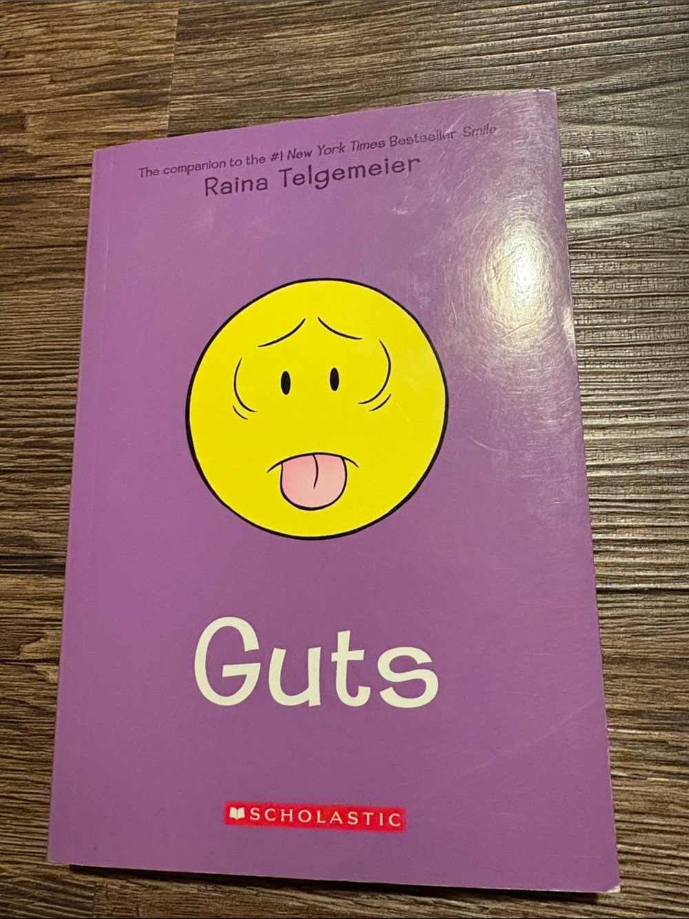 Scholastic Purple Paperback with Yellow Emoticon Face